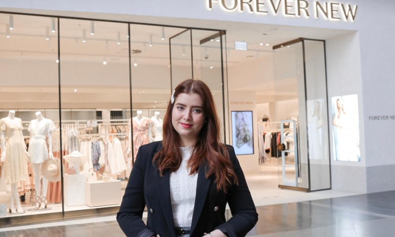 Personal stylist Brenda Nepomuceno standing outside a Forever New fashion boutique in Melbourne.